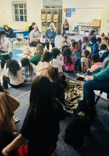 Miranda and Craig Coleman reading Chi's book to Broadview Elementary School.  Each child received a free copy of Chi's book.